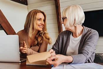 Two women looking over documents together