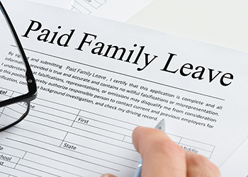 A person fills out a Paid Family Leave form