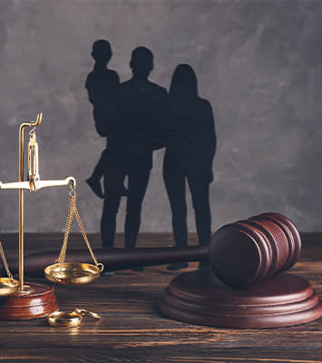 Family figures with judge's gavel and justice scales