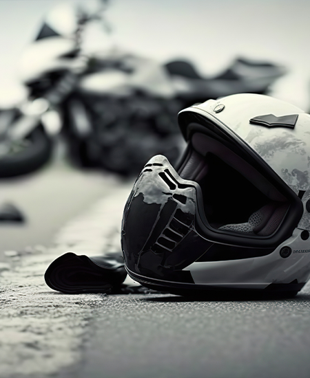 Motorcycle crash road accident with broken motorbike and helmet