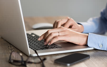 Woman typing at computer