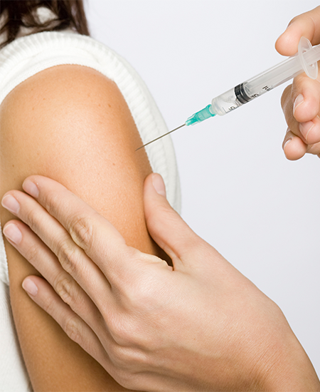 Nurse putting an injection in the arm