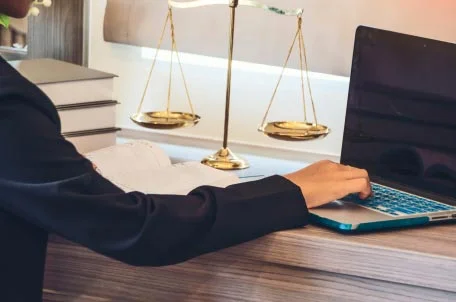 Person using laptop and scales