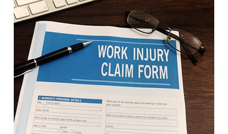 Work Comp Claim Form paper on desk