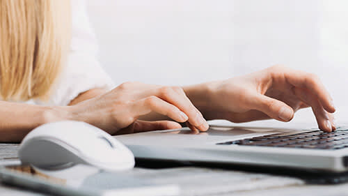 Woman typing at a computer
