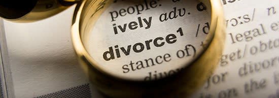Gold ring highlighting the word divorce in a dictionary