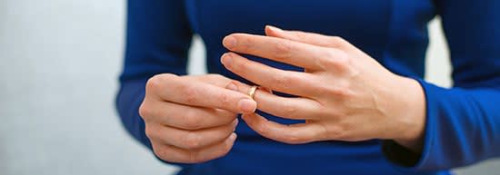 Woman removing a wedding ring