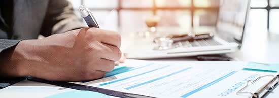 Man filling out insurance paperwork