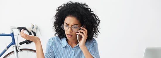 A frustrated woman talks on her cell phone
