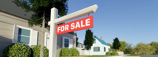 A for sale sign in front of a house