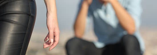 Woman walking away from a distraught man