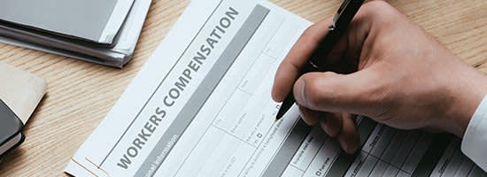 A person filling out a workers compensation document