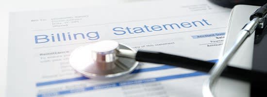 Stethoscope resting on a billing statement