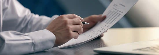 Business man looking over a document