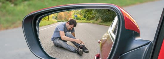 Man Gripping Ankle in Road