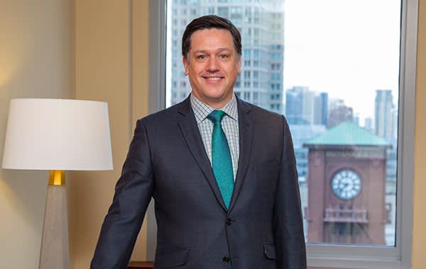 Attorney John Gorey in suit standing in office