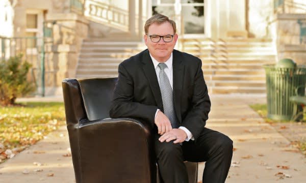 Attorney Edward E. Cox Sitting on a Couch
