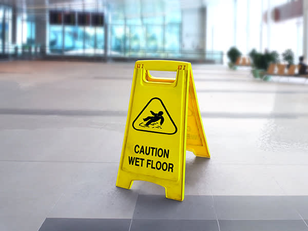 Wet floor sign in the middle of a floor in a building