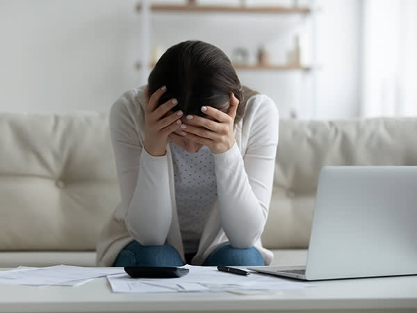 Woman in distress with her head in her hands