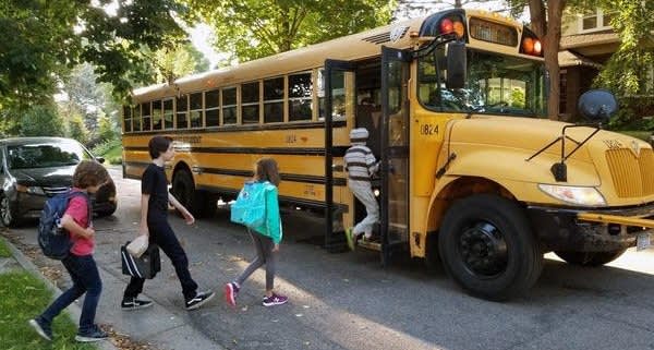 Students Getting on School Bus.