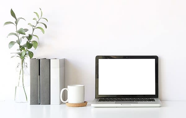 Clean desk with a computer and books