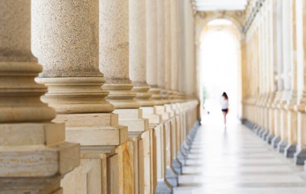 Courthouse columns and someone walking in the distance