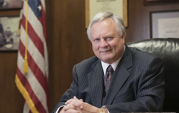 John Lueck sitting at a desk