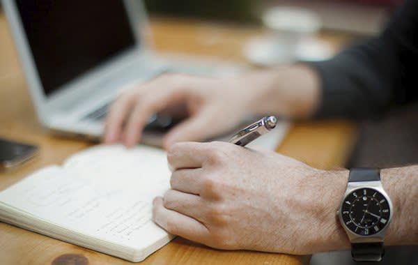 Man writing on a desk