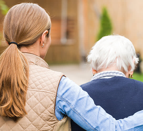 Woman escorting elderly lady