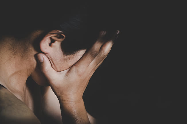 Woman crying into her hands