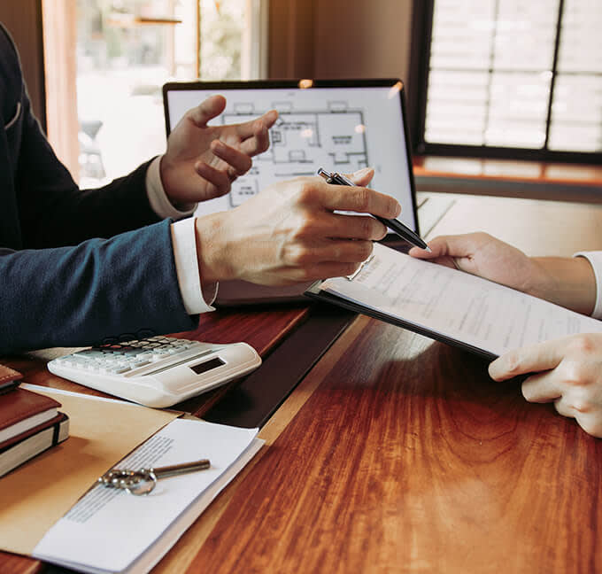 A businessman discussing paperwork with a client