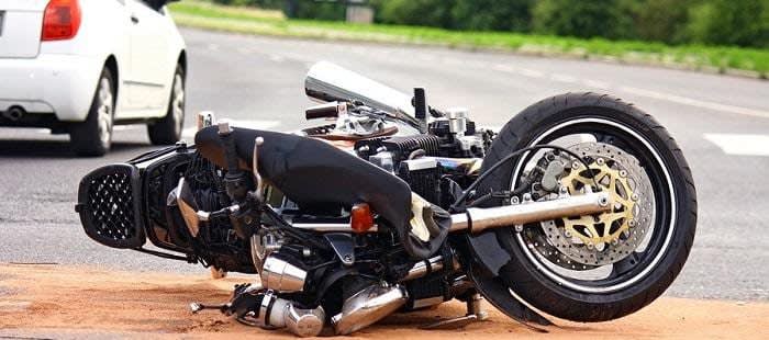 Motorcycle tipped over on road