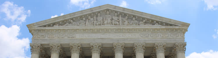 Front of courthouse that reads EQUAL JUSTICE UNDER LAW