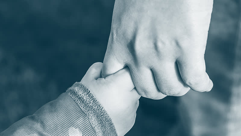 Adult and child holding hands