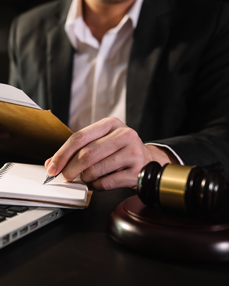 Male judge in a courtroom with the gavel, working with, computer