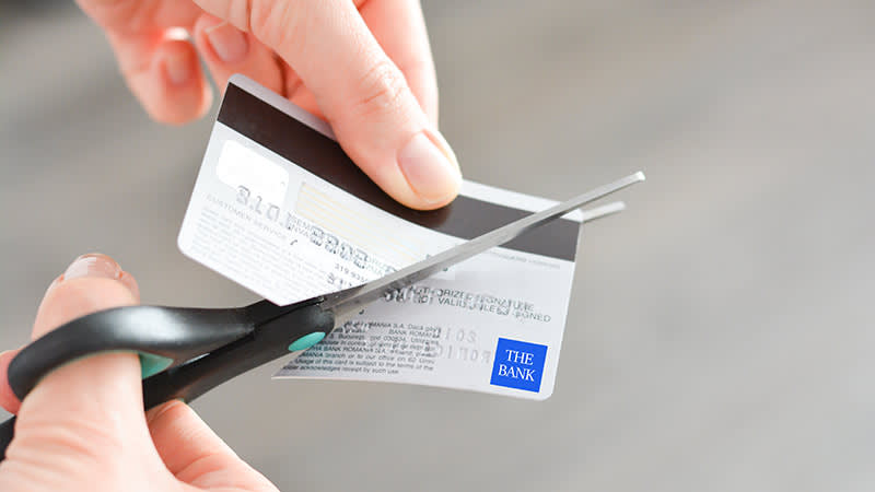 Person cutting a credit card