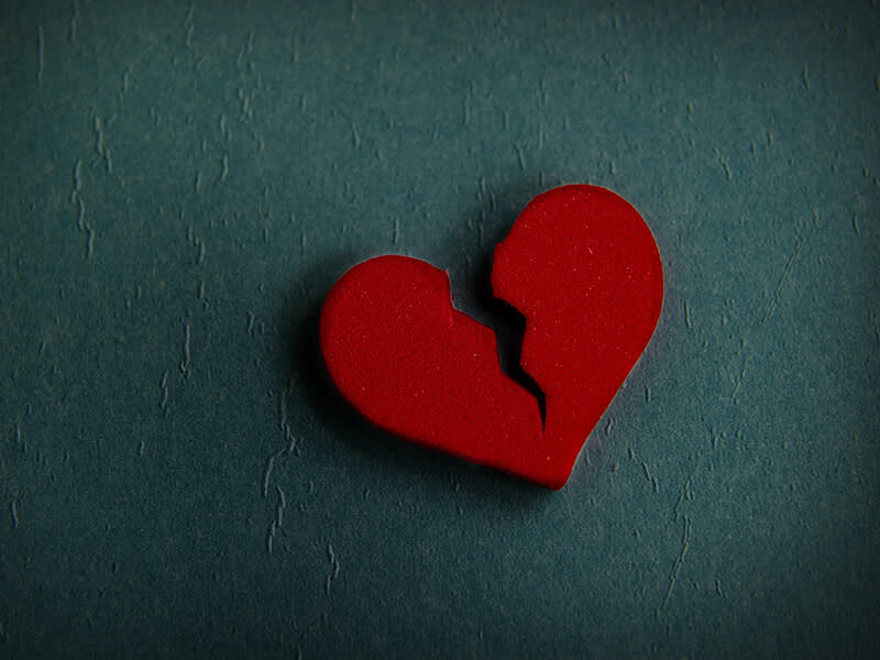 Broken heart on a blue textured background