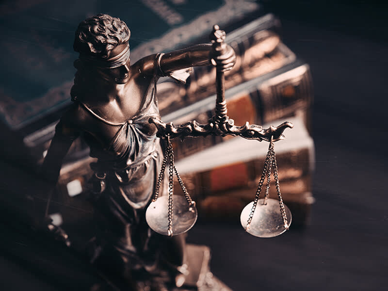 Lady of justice near a stack of books