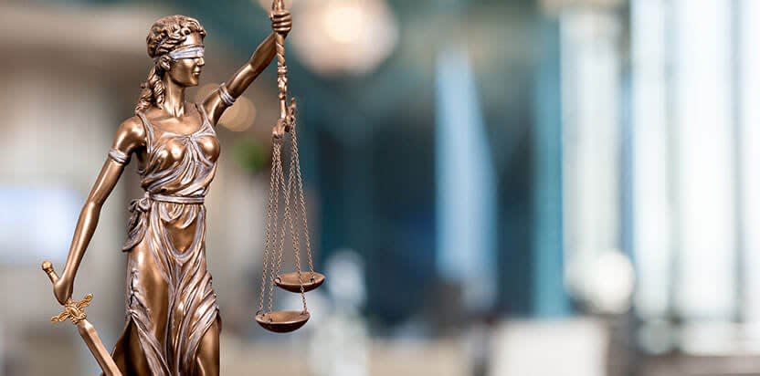 bronze lady justice holding scales of justice