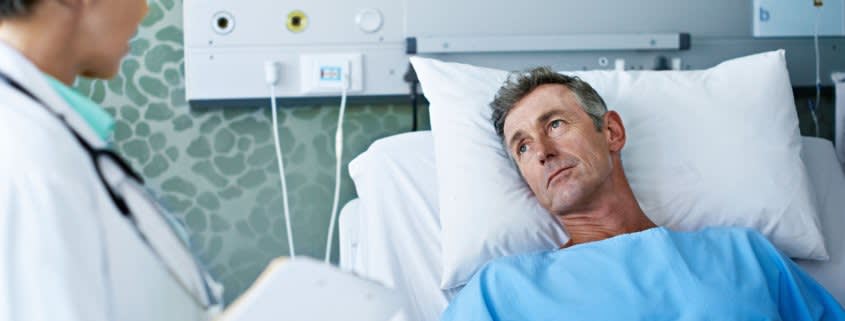 Elderly Man Lying in a Hospital Bed