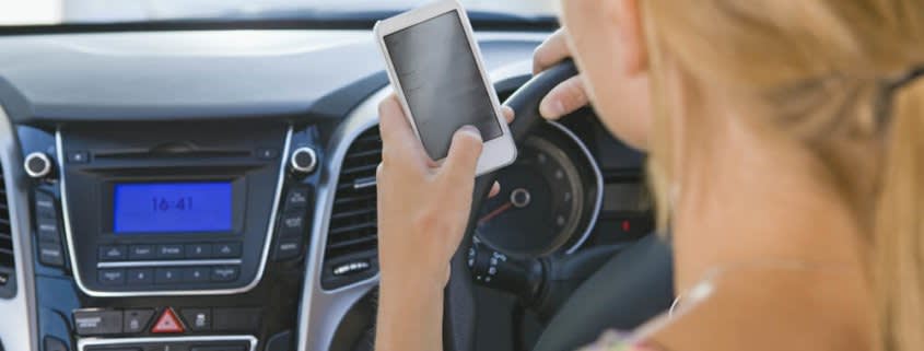 Woman Holding Phone While Driving