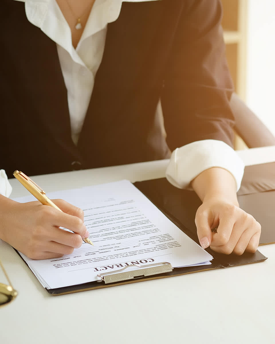 Women in suit signing a document