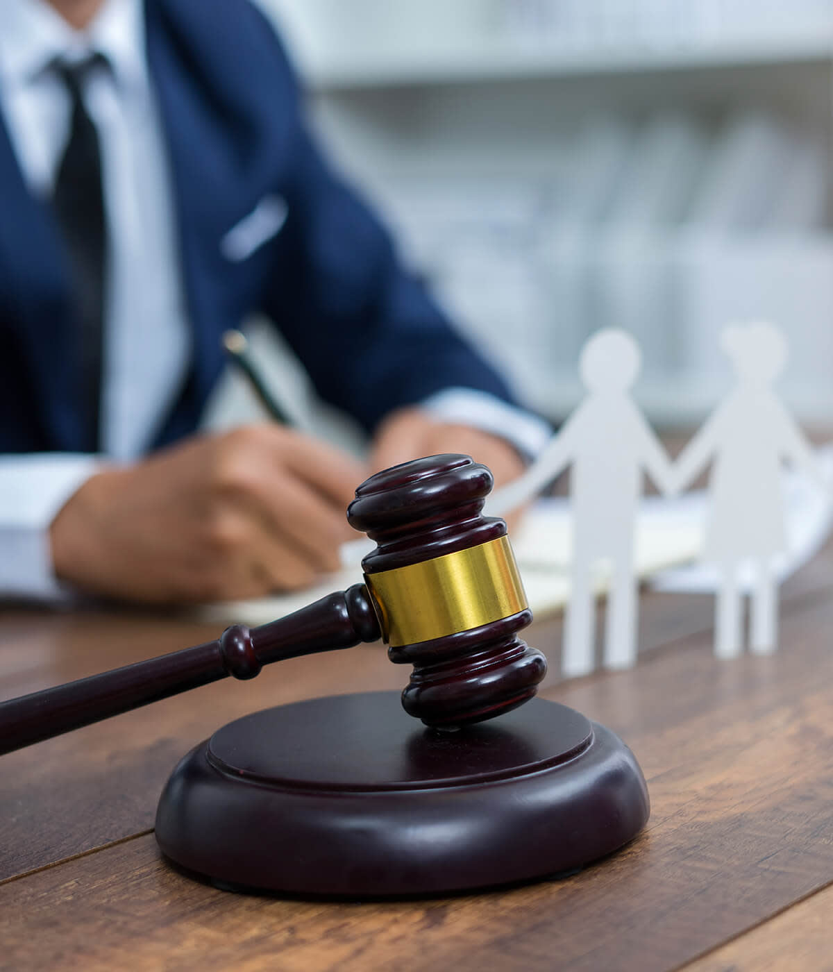Family figure cutouts and gavel on table