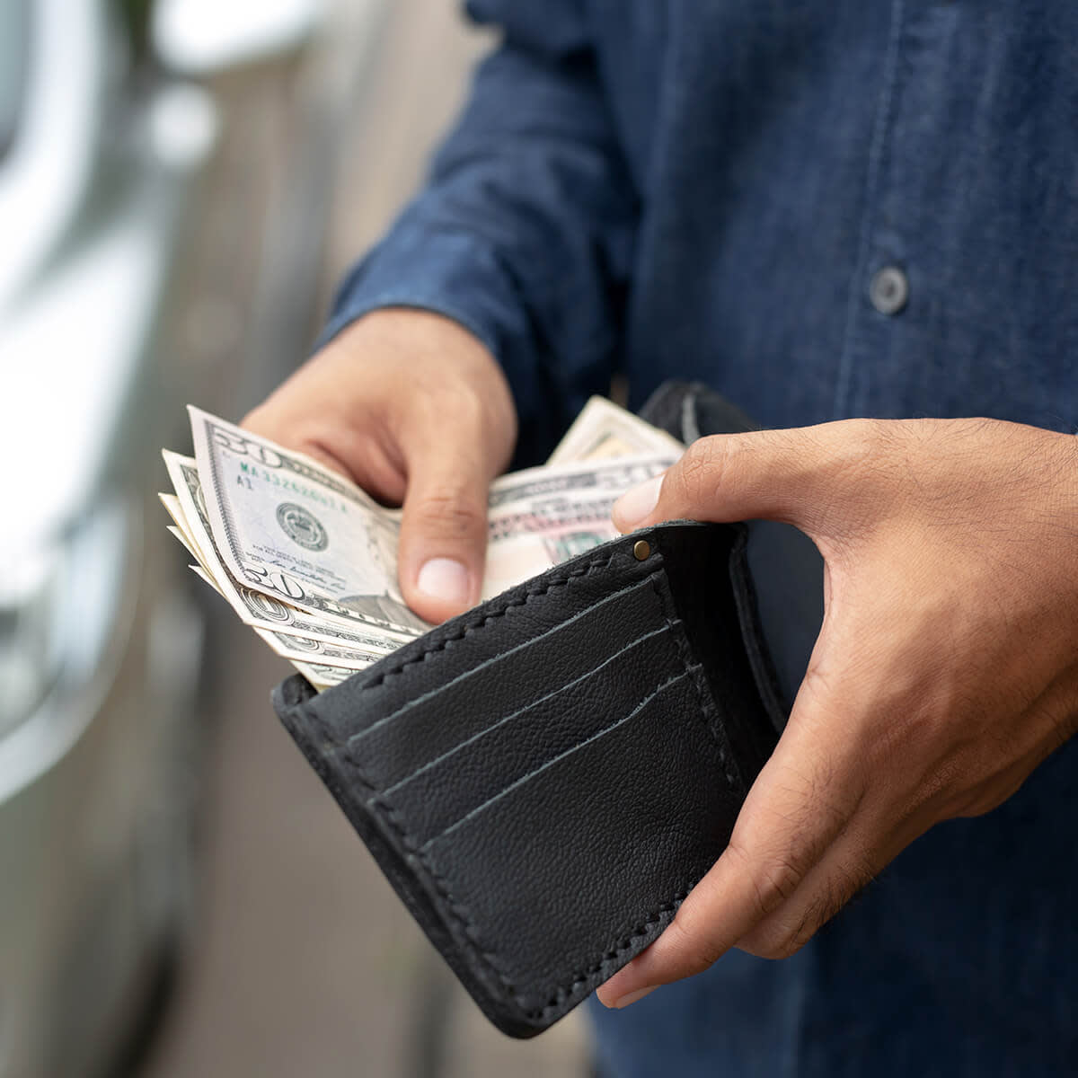 Businessman Person holding a wallet in the hands of take money out of pocket