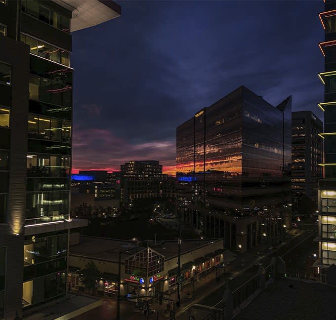 Boise Idaho in the evening with building lights glowing