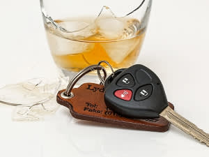 Glass of alcohol and car keys nearby