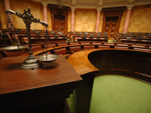 Scales of justice in an empty courtroom