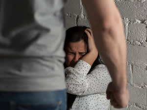 Man standing over a girl in fear