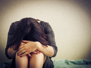 Girl in distress curled up on floor