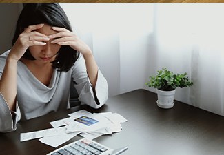 Asian woman pressing 2 hands on forehead with feeling stress, unhappy, worry and watching to receipt.